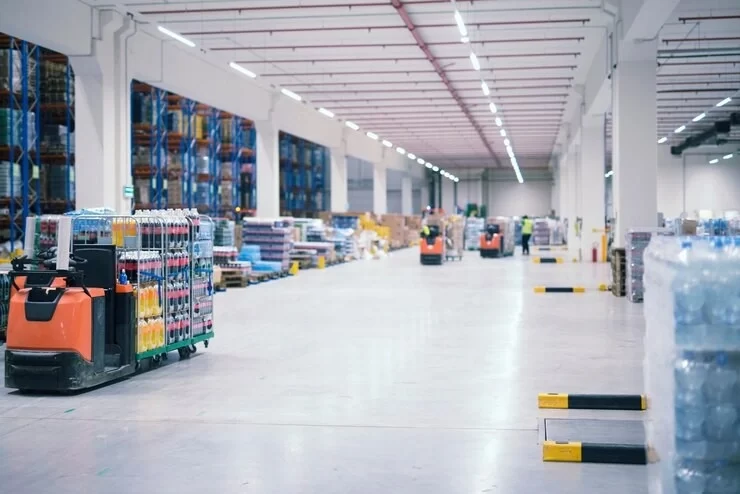 warehouse-industrial-building-interior-with-people-forklifts-handling-goods-storage-area_342744-1498